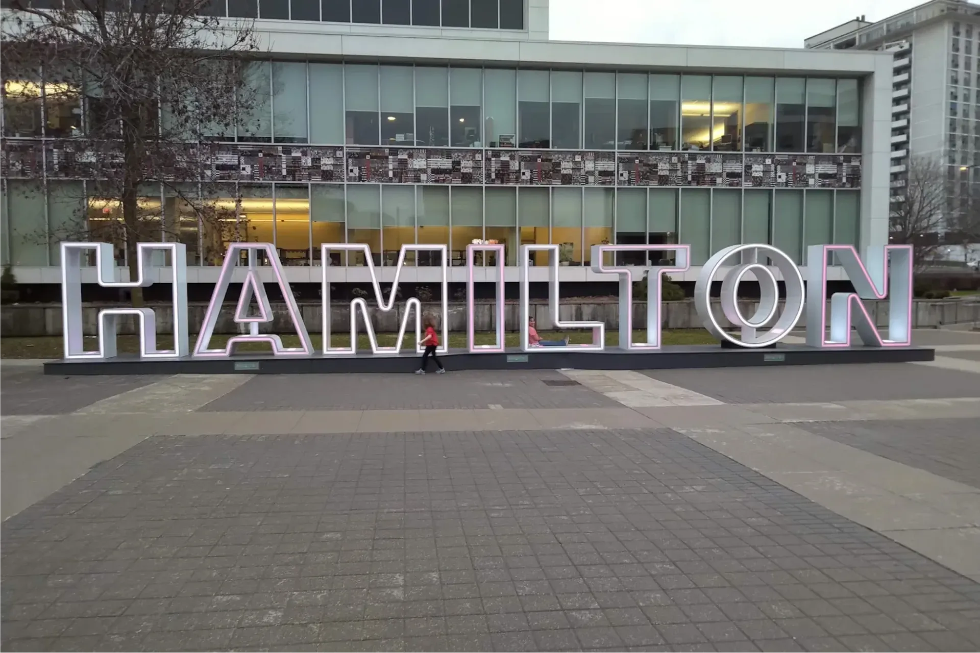 A large 'Hamilton' sign on pavers at City Hall.