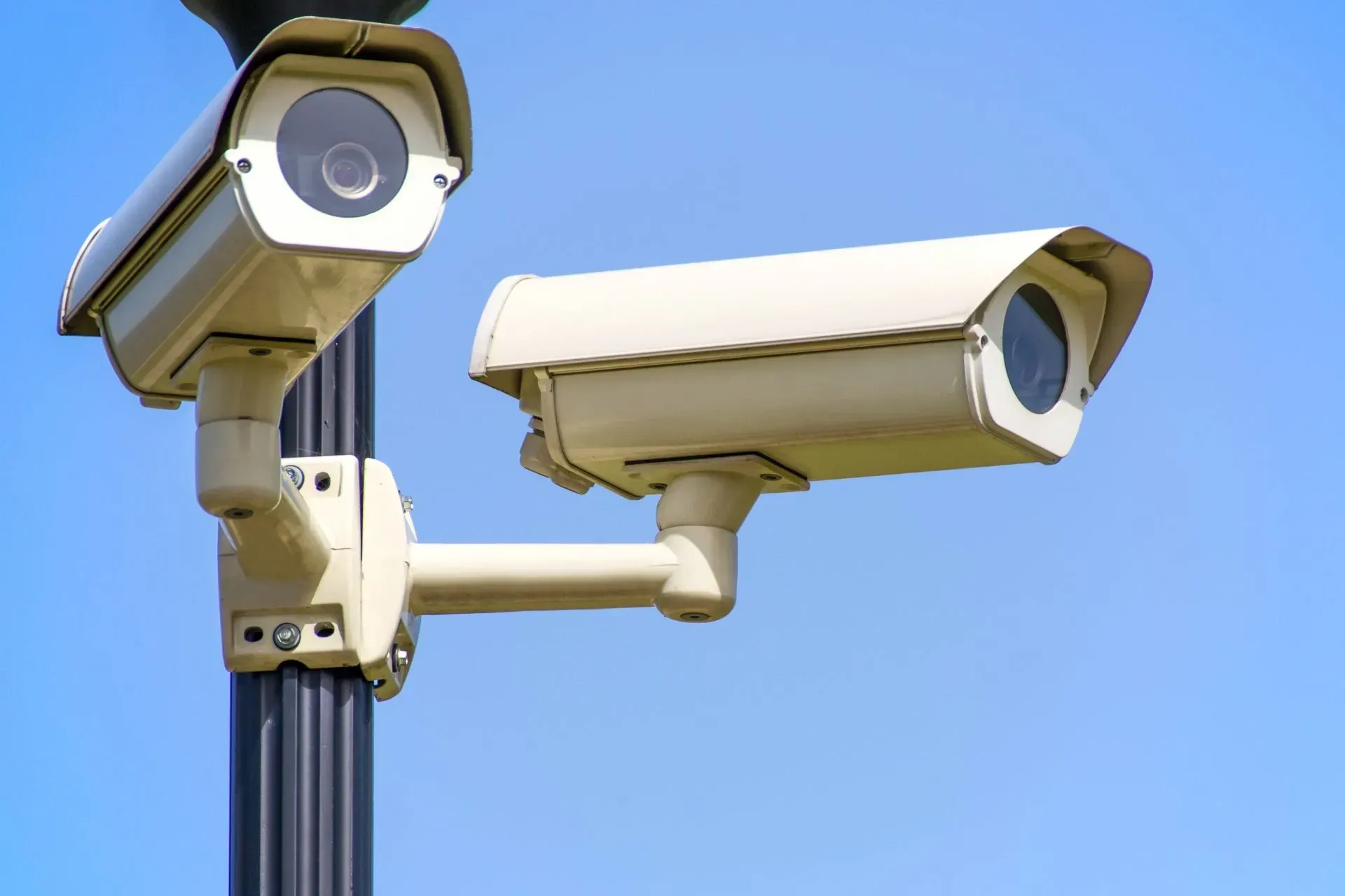 Two security cameras mounted on a pole