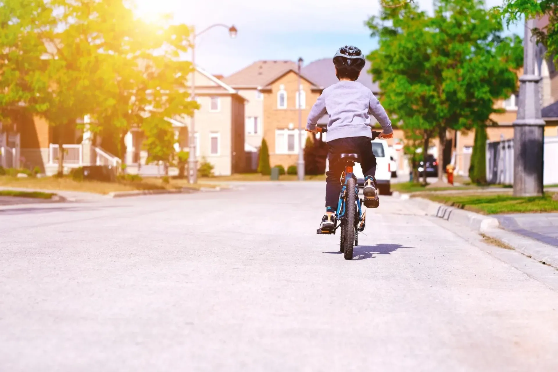 Child biking on a street in Millcroft, Burlington