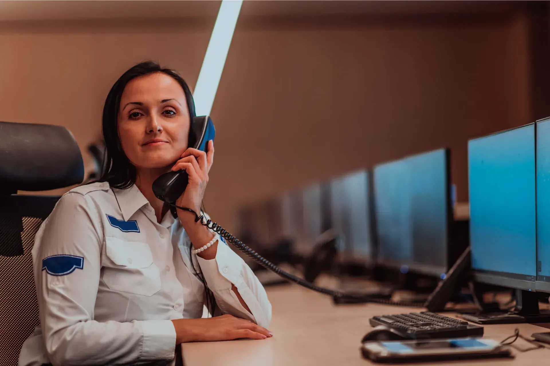 A female remote security operator in the middle of a call