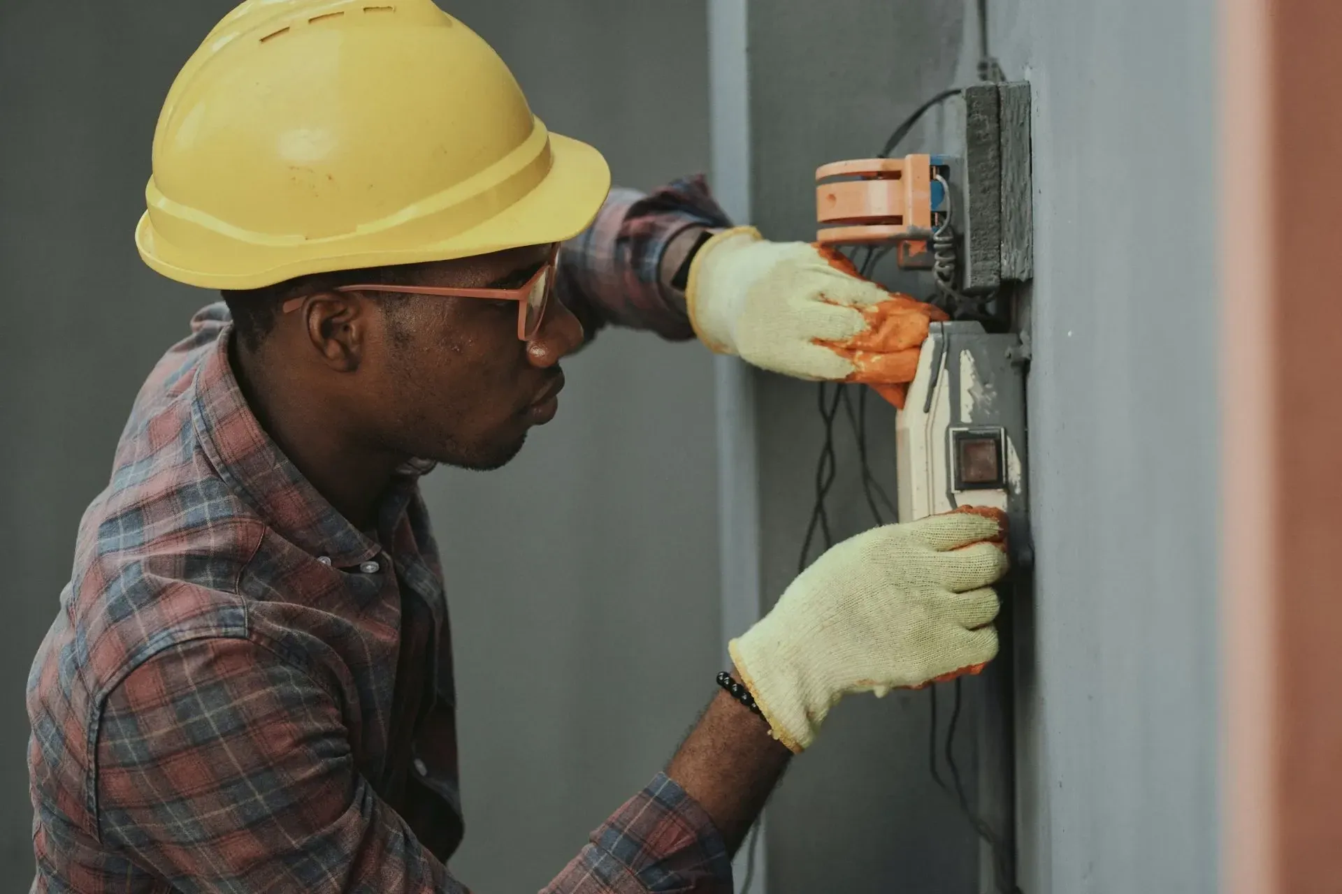Electrician splicing security camera wires and coaxial cable