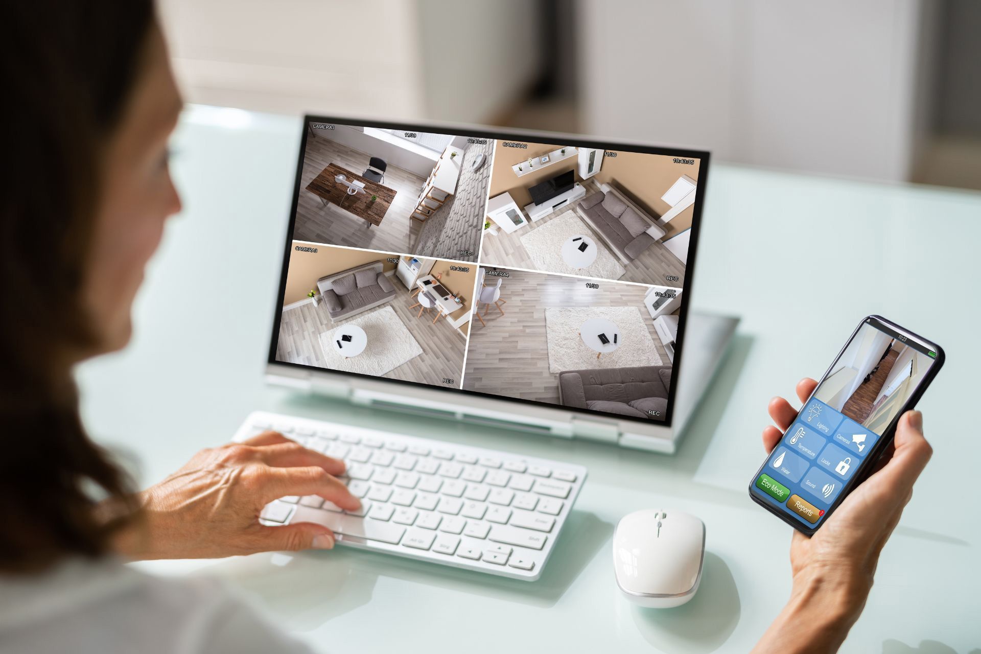 A woman remotely viewing CCTV live feed on her home through her laptop and security camera app