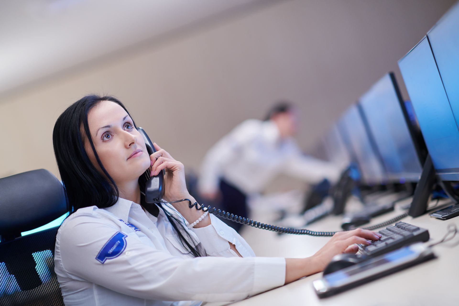 A female remote security operator in the middle of a call
