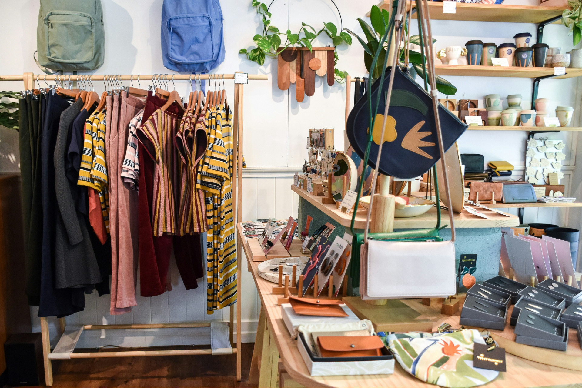 Colourful clothes and accessories on display inside a small-business clothing shop