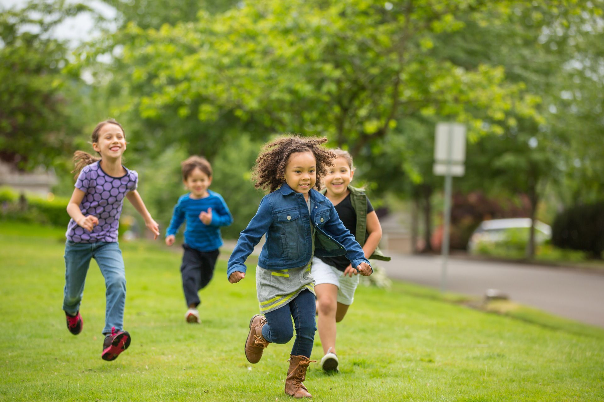 Four children play in a park in a Toronto neighbourhood