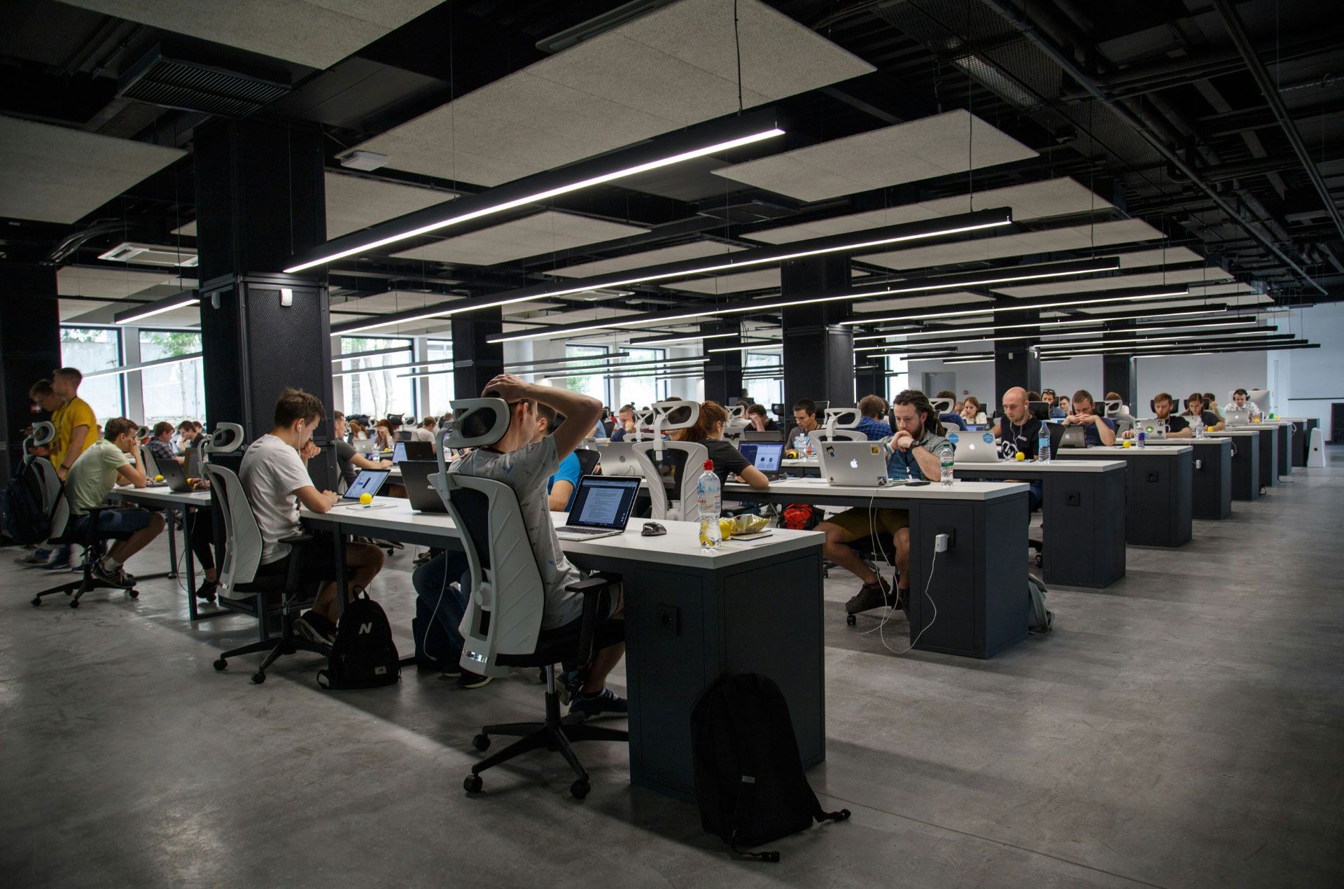 The interior of a workplace with many employees at their desks