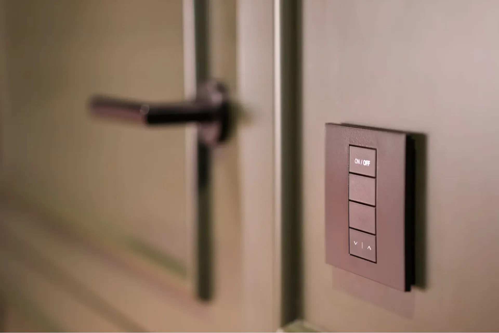 Close-up of a smart lock mounted next to a door and door handle. 
