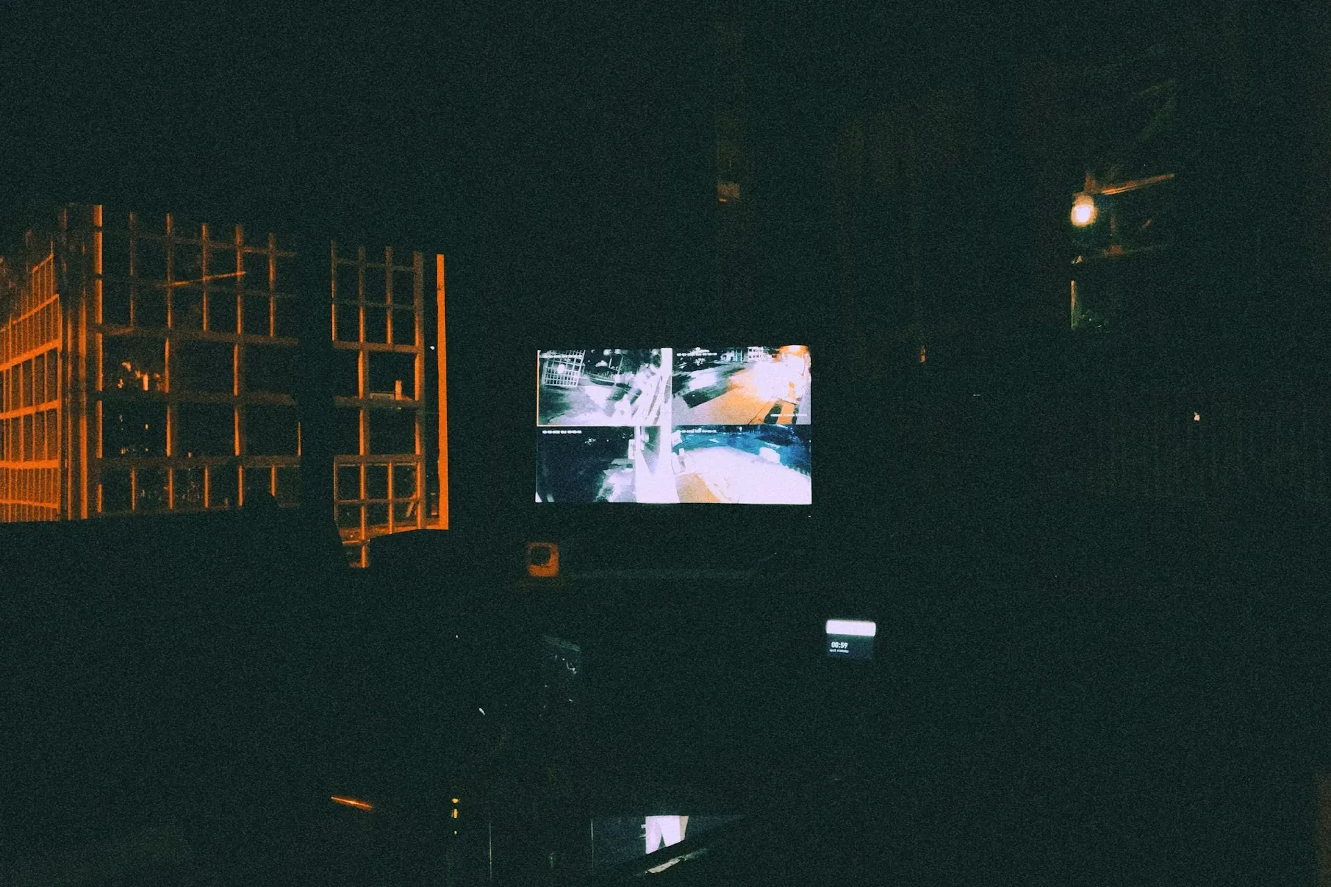 CCTV video recording on a screen in a dark room