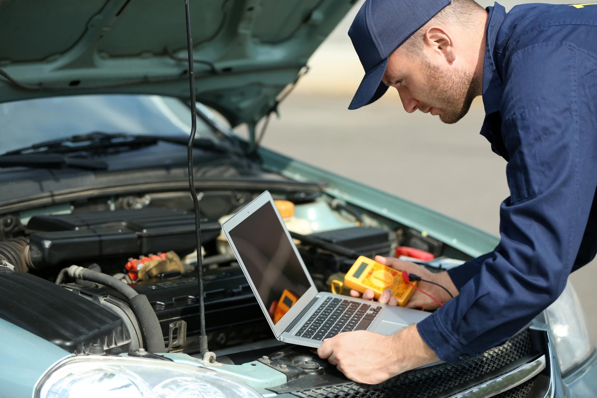 Mechanic installing a GPS inside a vehicle