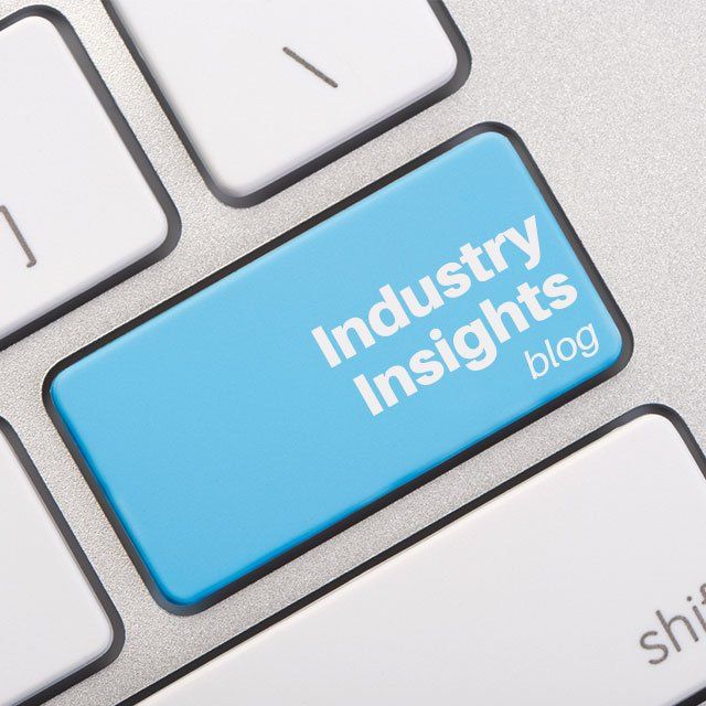 A blue button on a keyboard that says industry insights blog