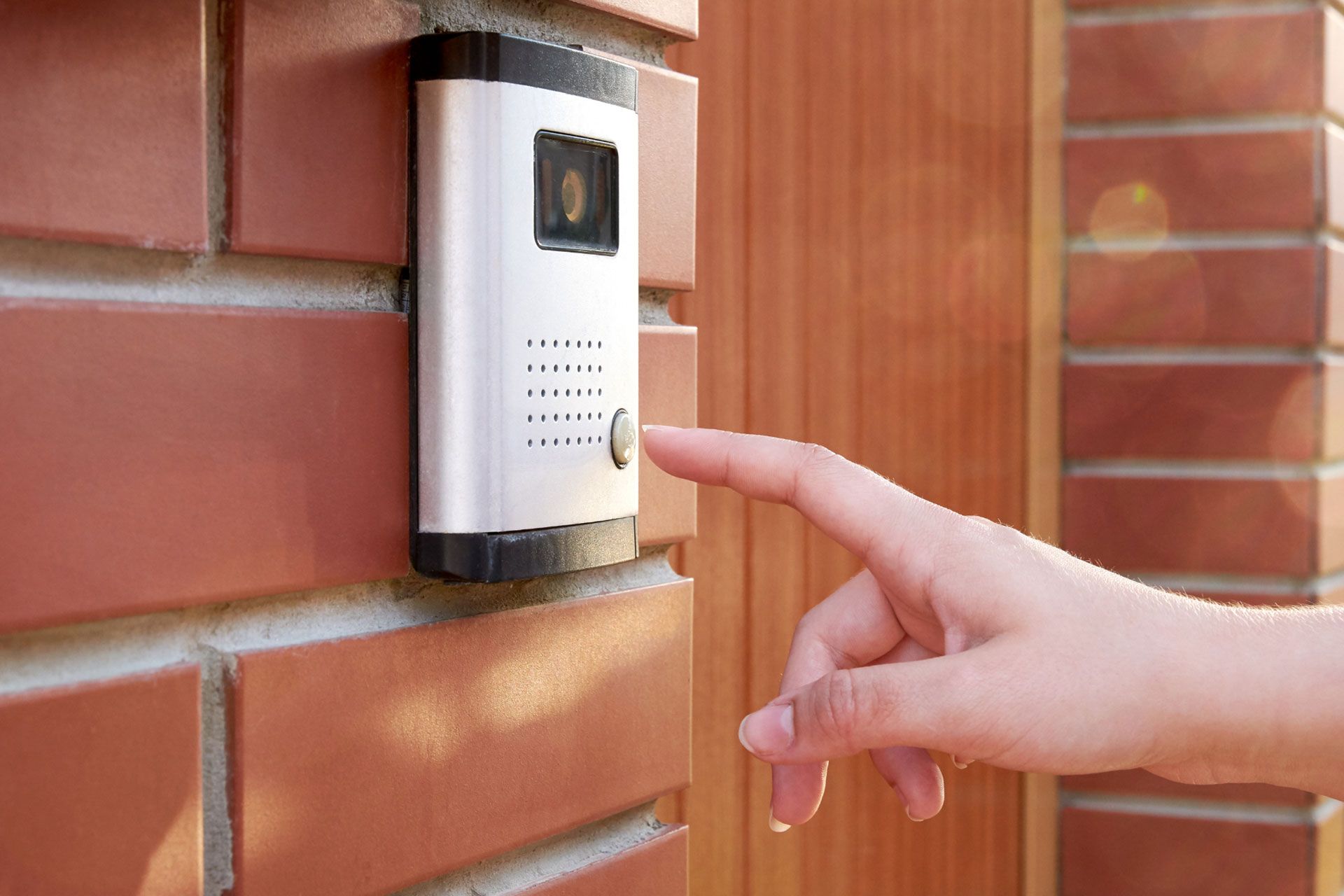 A doorbell camera about to be pressed