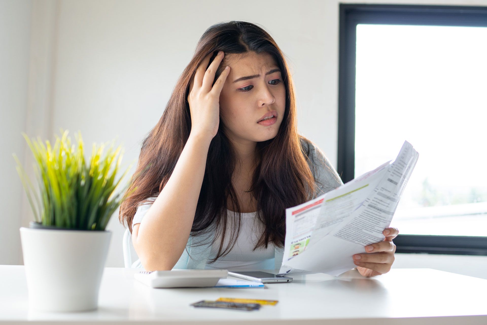 Homeowner looking distressed at bills