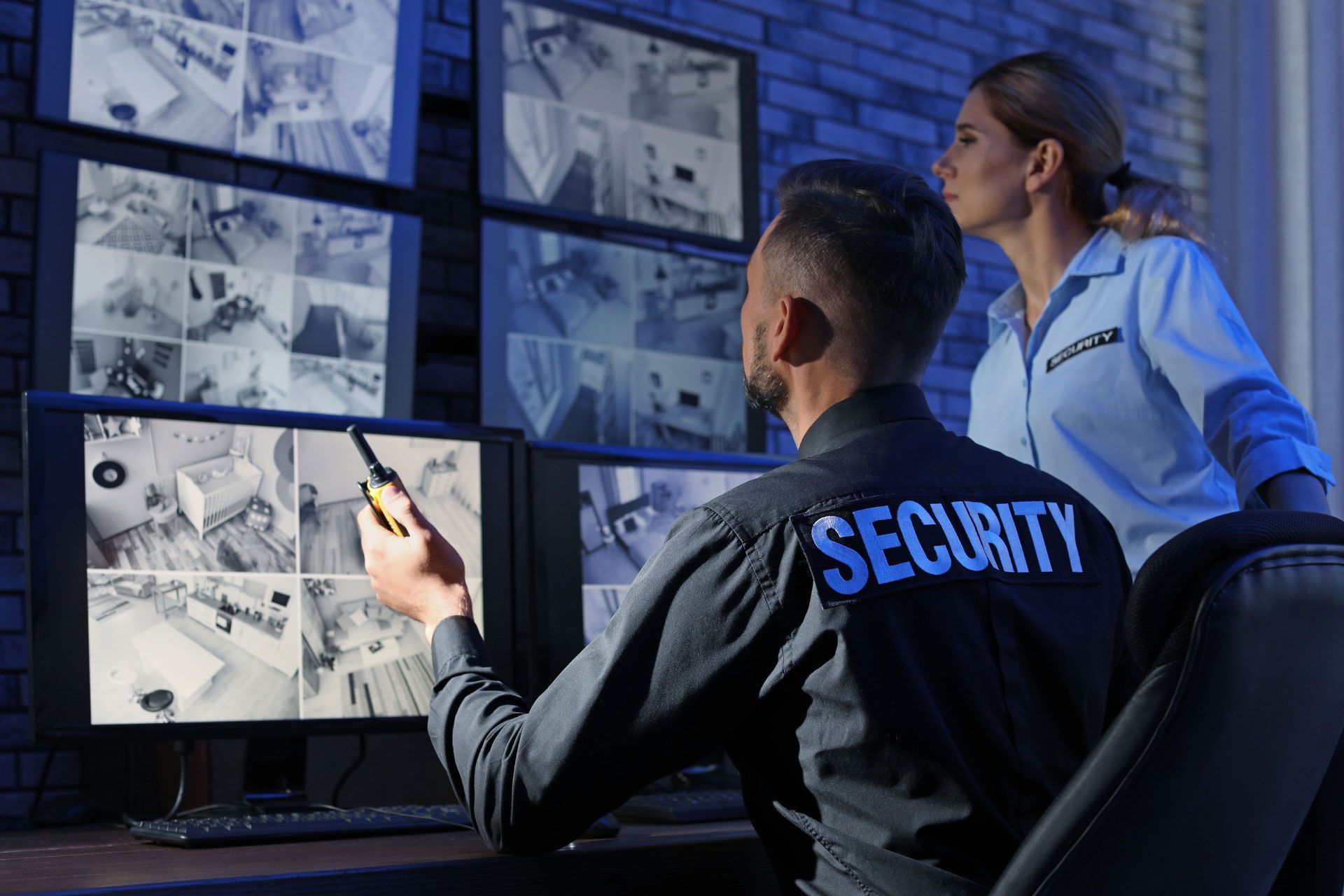 Security experts monitoring surveillance cameras
