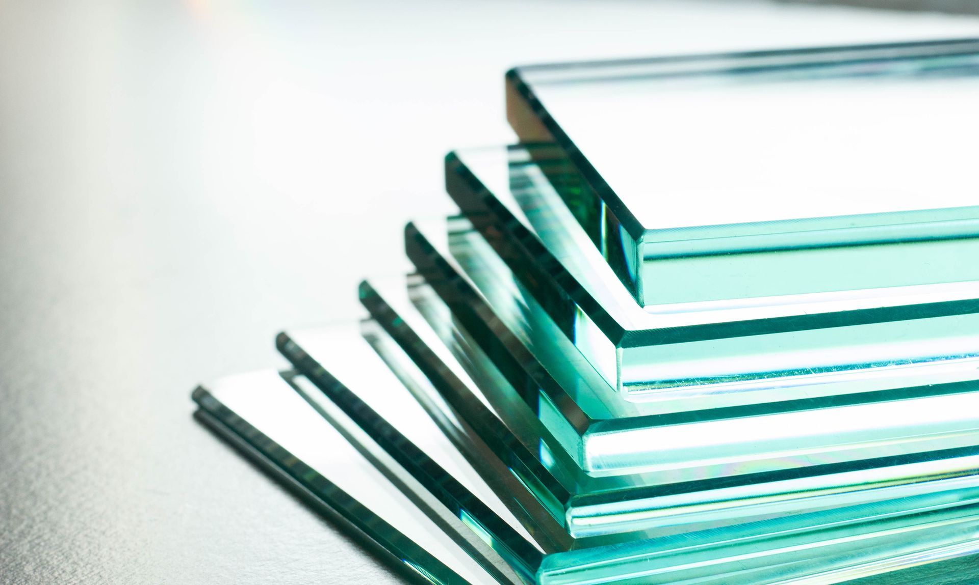 A stack of clear glass pieces sitting on top of each other on a table.