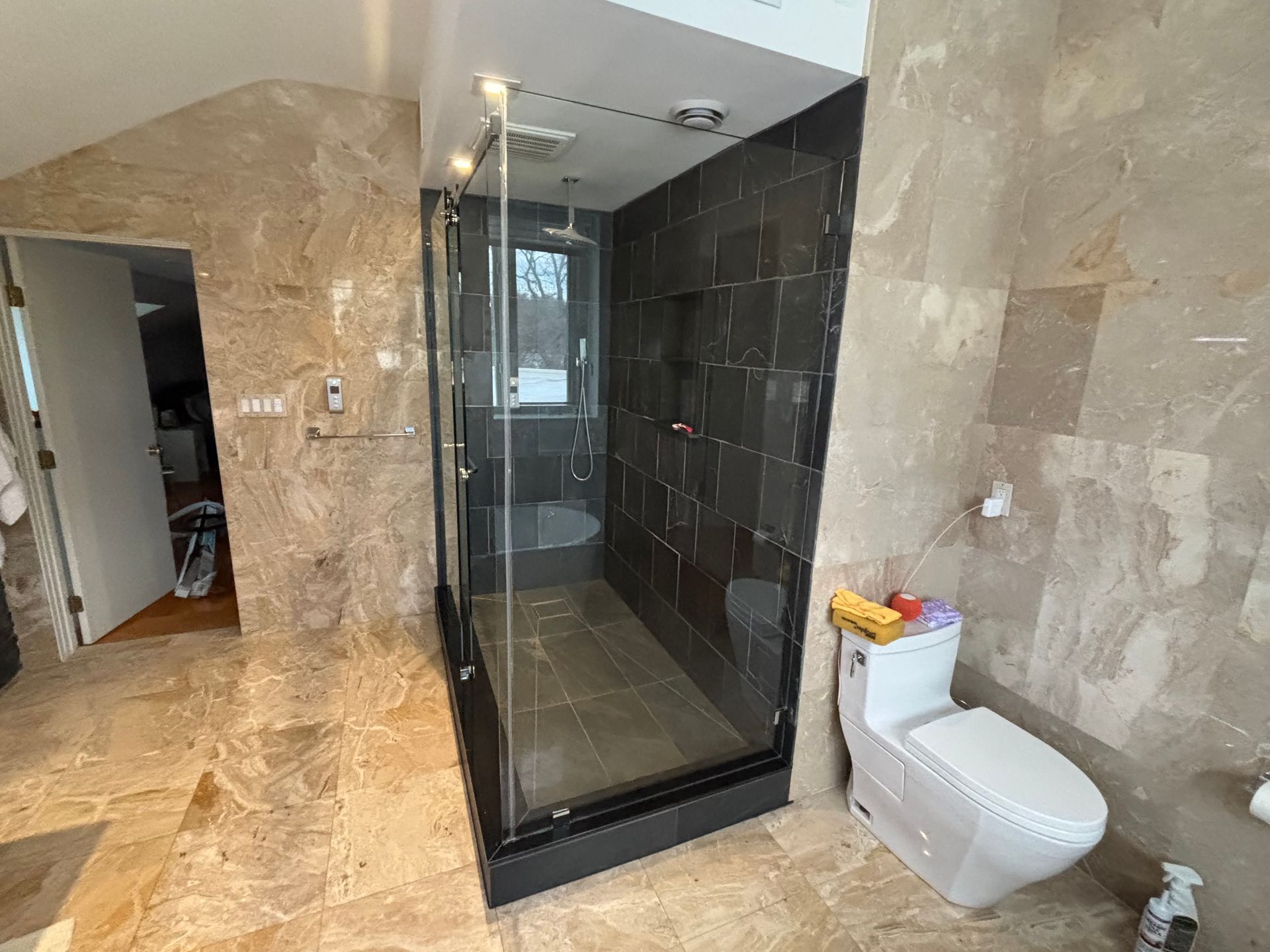 A bathroom with a tub , shower and window.