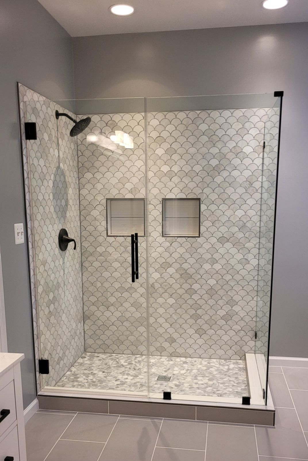 A bathroom with two sinks and two mirrors