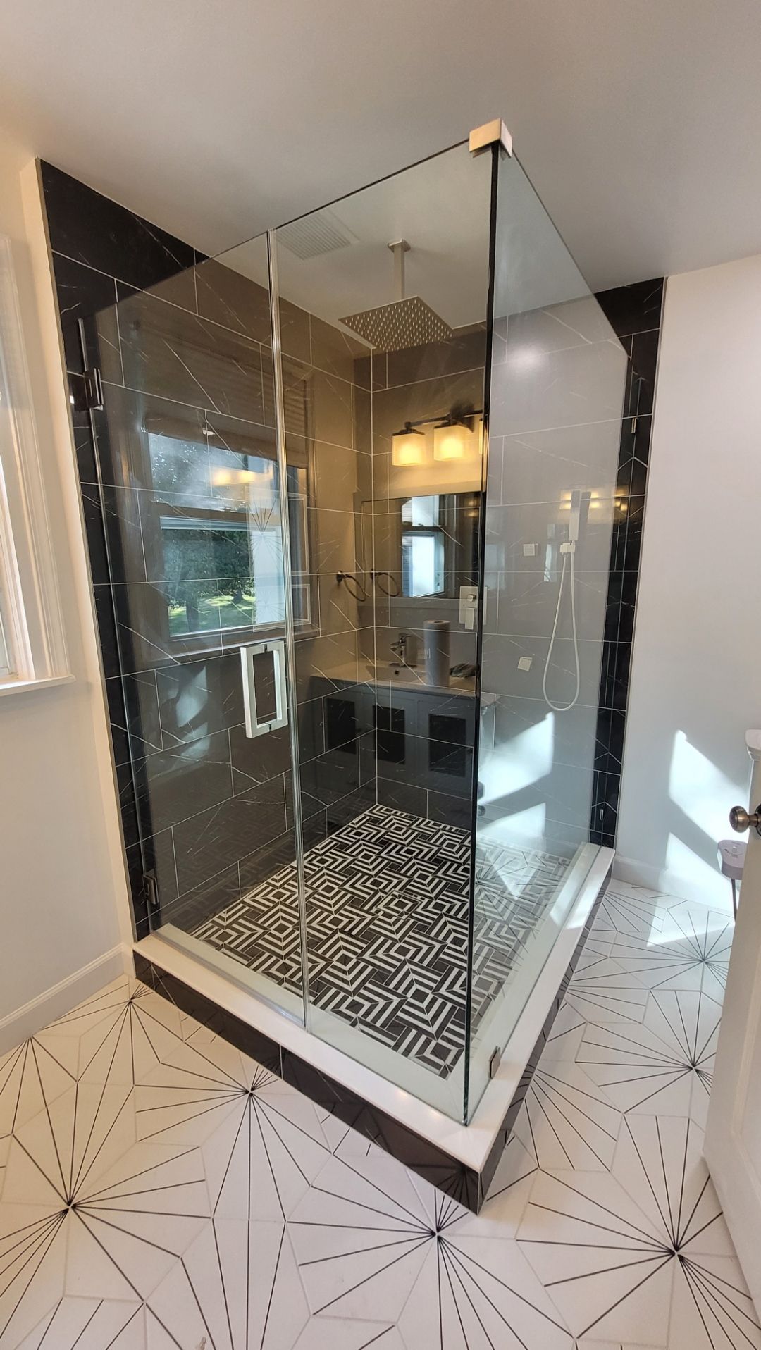 A bathroom with a toilet and a walk in shower.
