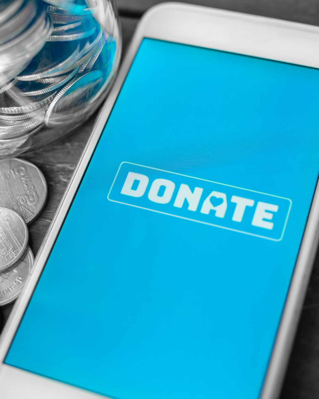 A cell phone with a blue screen that says donate on it.