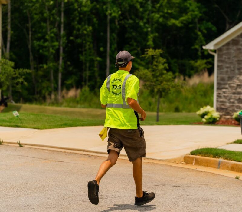 A man wearing a yellow shirt that says ds on it
