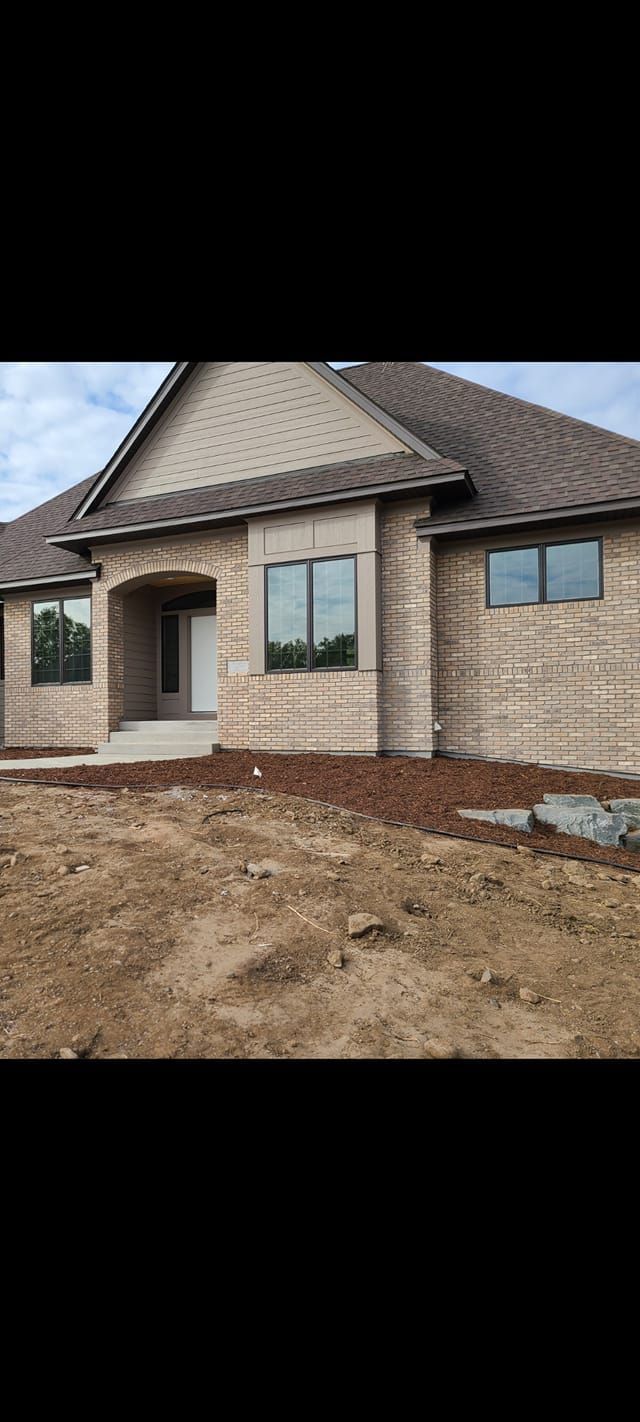 A house is being built in the middle of a dirt field.