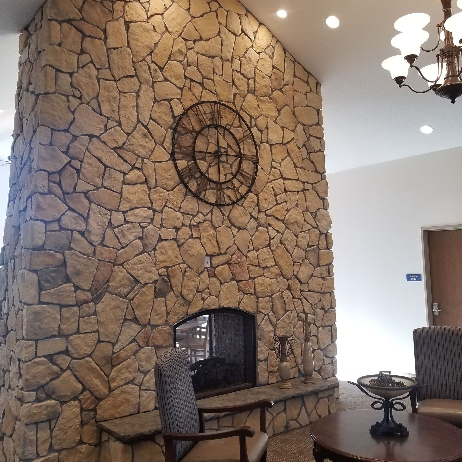 A large stone fireplace with a clock above it
