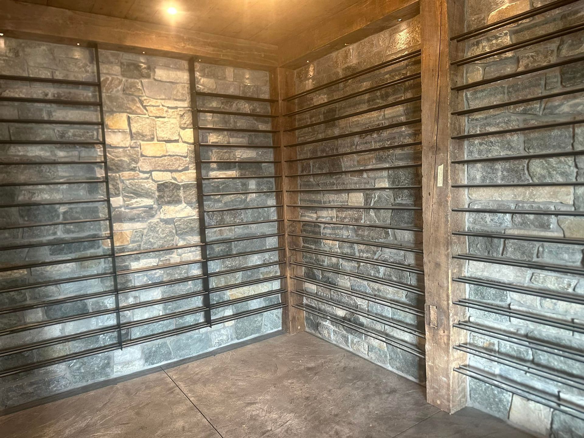 A room with a lot of shelves and brick walls.