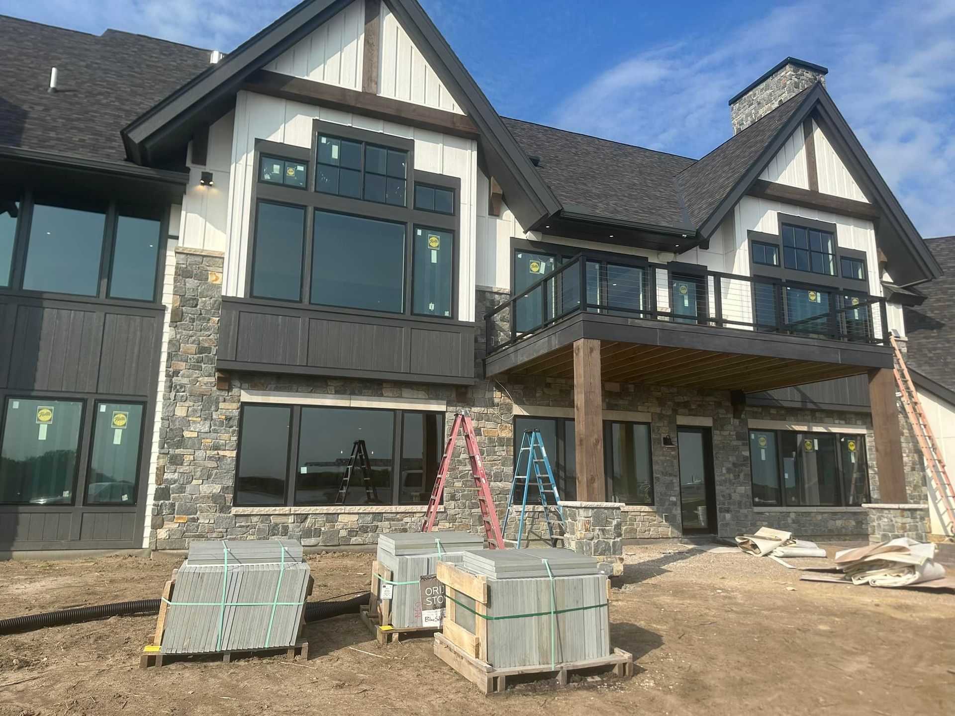 A large house with a lot of windows is being built.