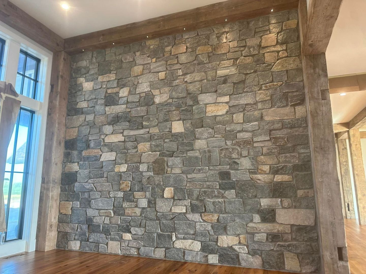 There is a large stone wall in the middle of the room.
