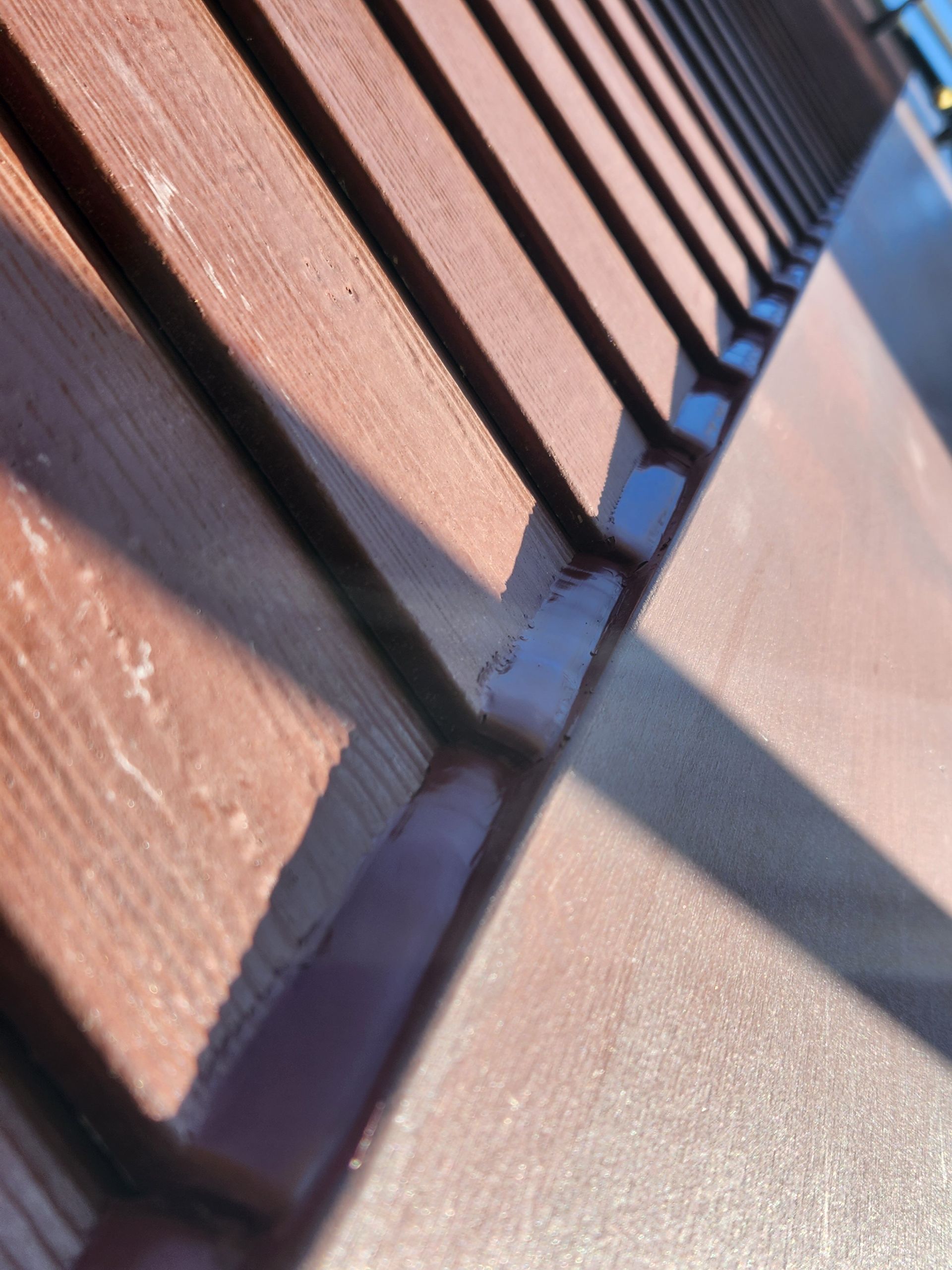 Un gros plan d'une balustrade en bois sur un trottoir