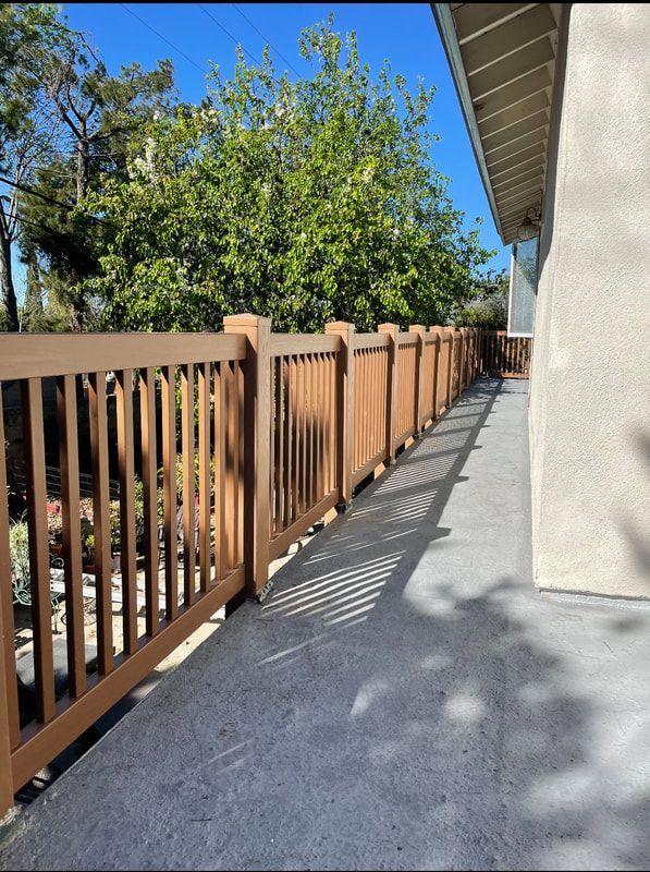 A wooden fence along the side of a house