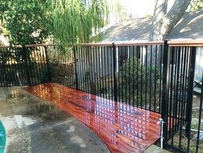A wooden deck with a metal fence around it.