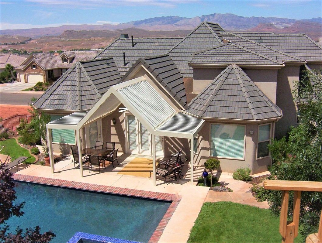 A large house with a swimming pool in front of it