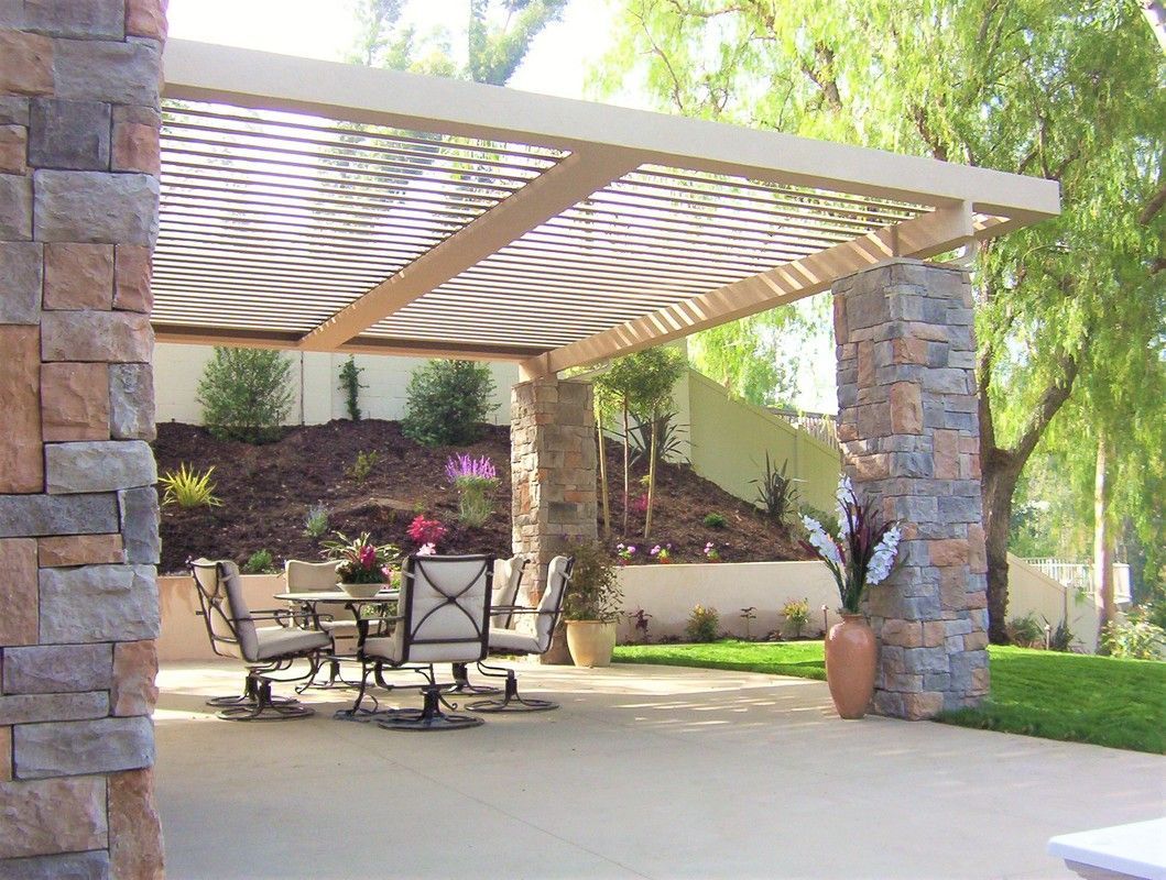 A patio with a table and chairs under a pergola