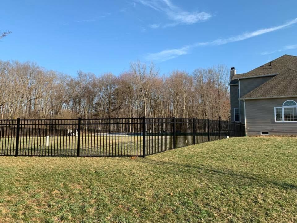 There is a fence in the backyard of a house.