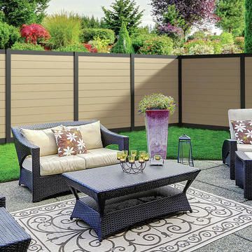 A patio with a couch , chairs , and a coffee table.