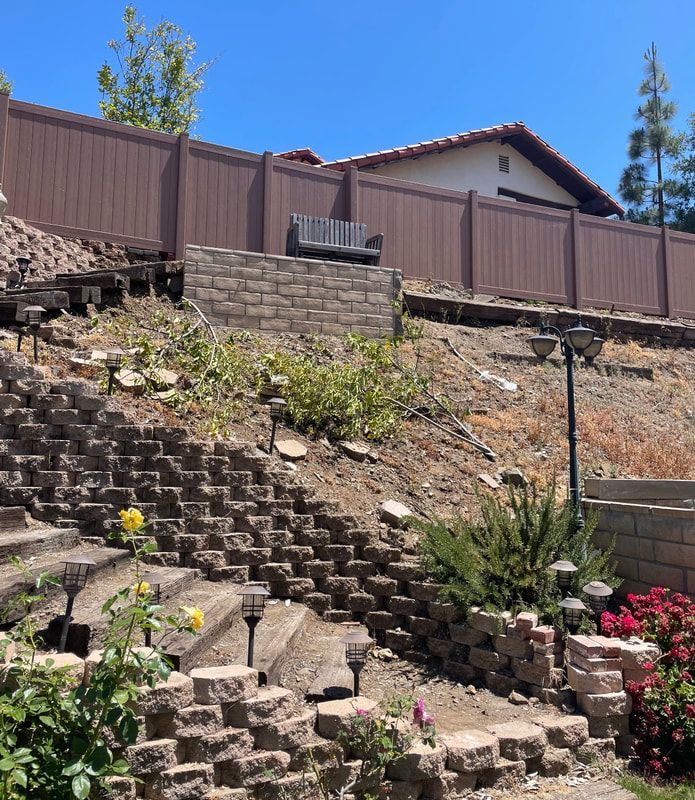 Stairs leading up to a house with a wooden fence
