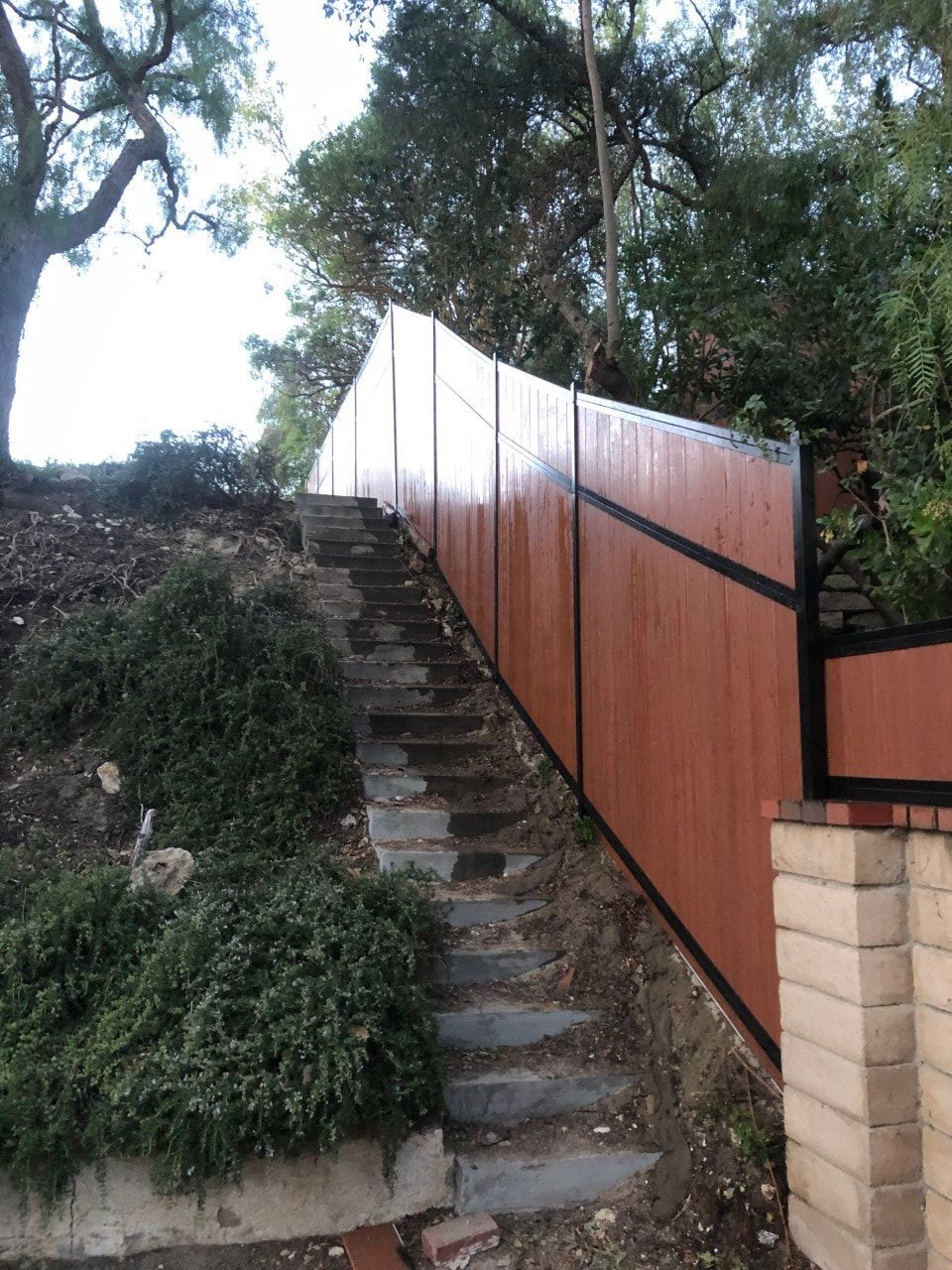 A wooden fence with stairs leading up to it