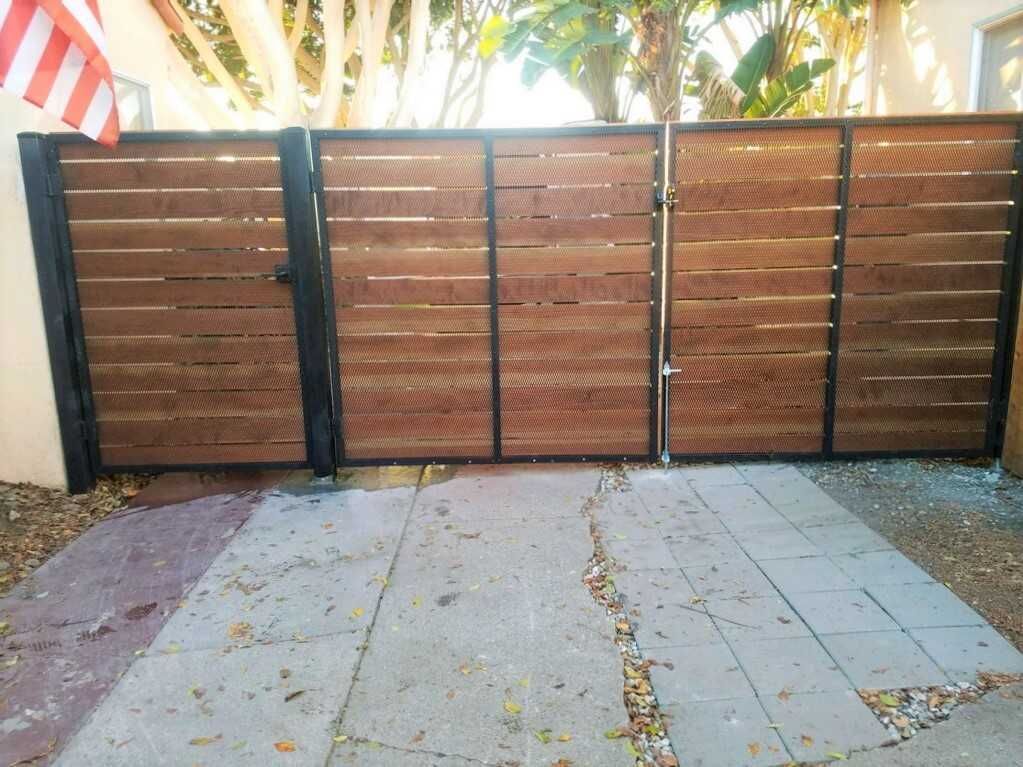 A wooden fence is sitting on top of a concrete driveway.