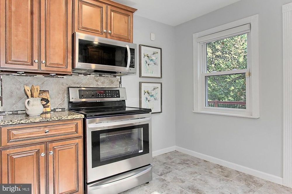 A kitchen with stainless steel appliances and wooden cabinets.