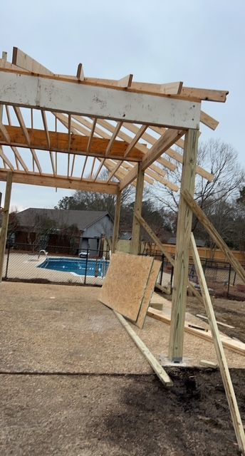 A wooden structure is being built next to a pool.