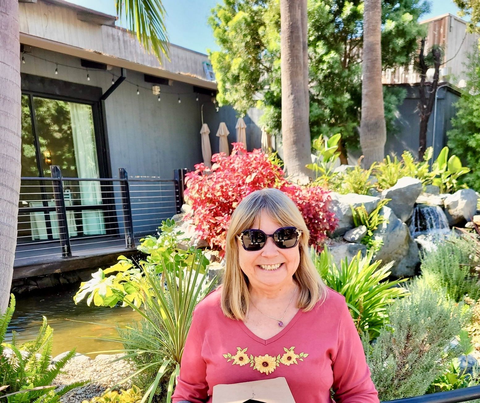 A vase of flowers is sitting on a table next to a window.
