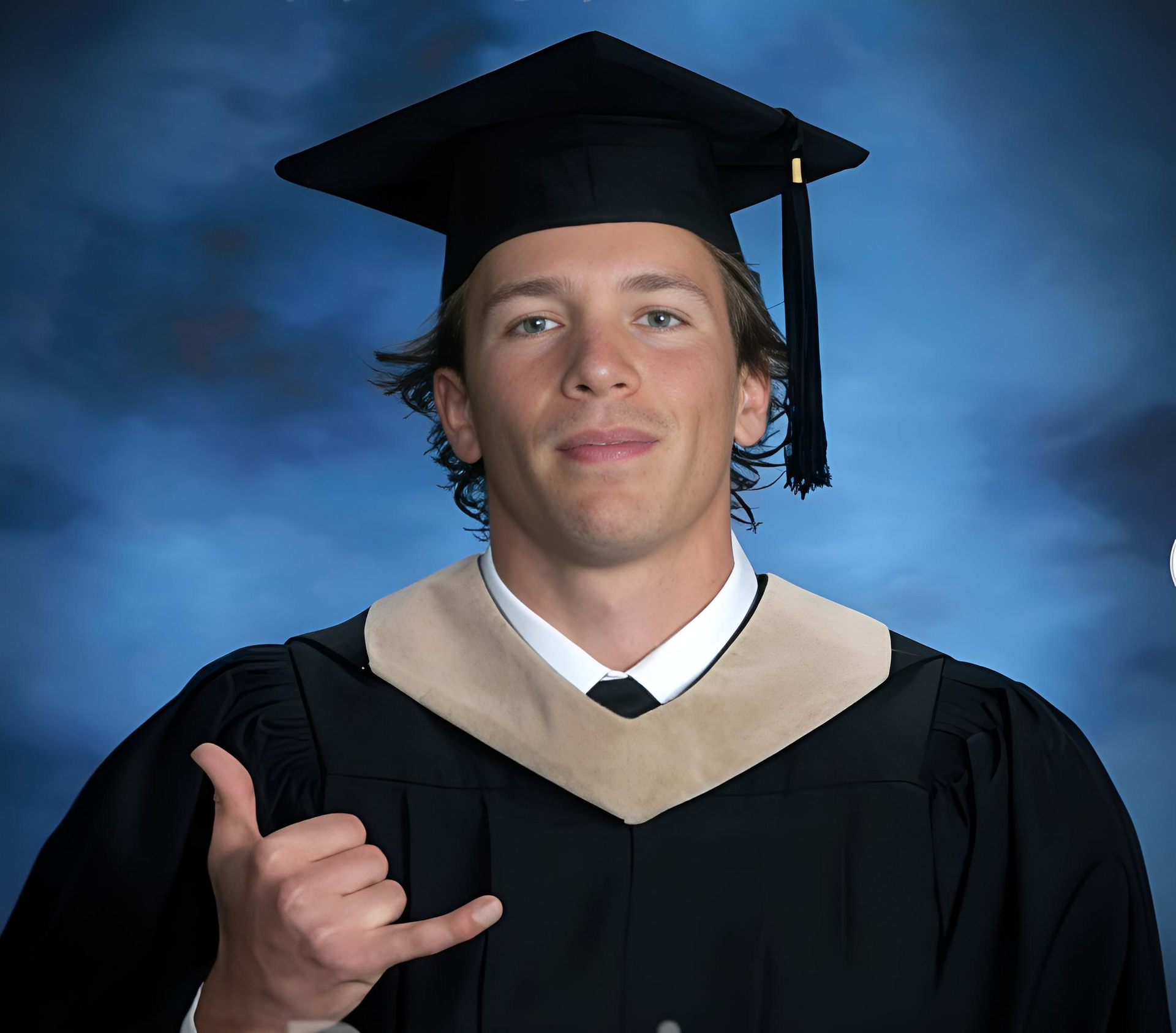 a man in a light blue shirt is holding a soccer ball