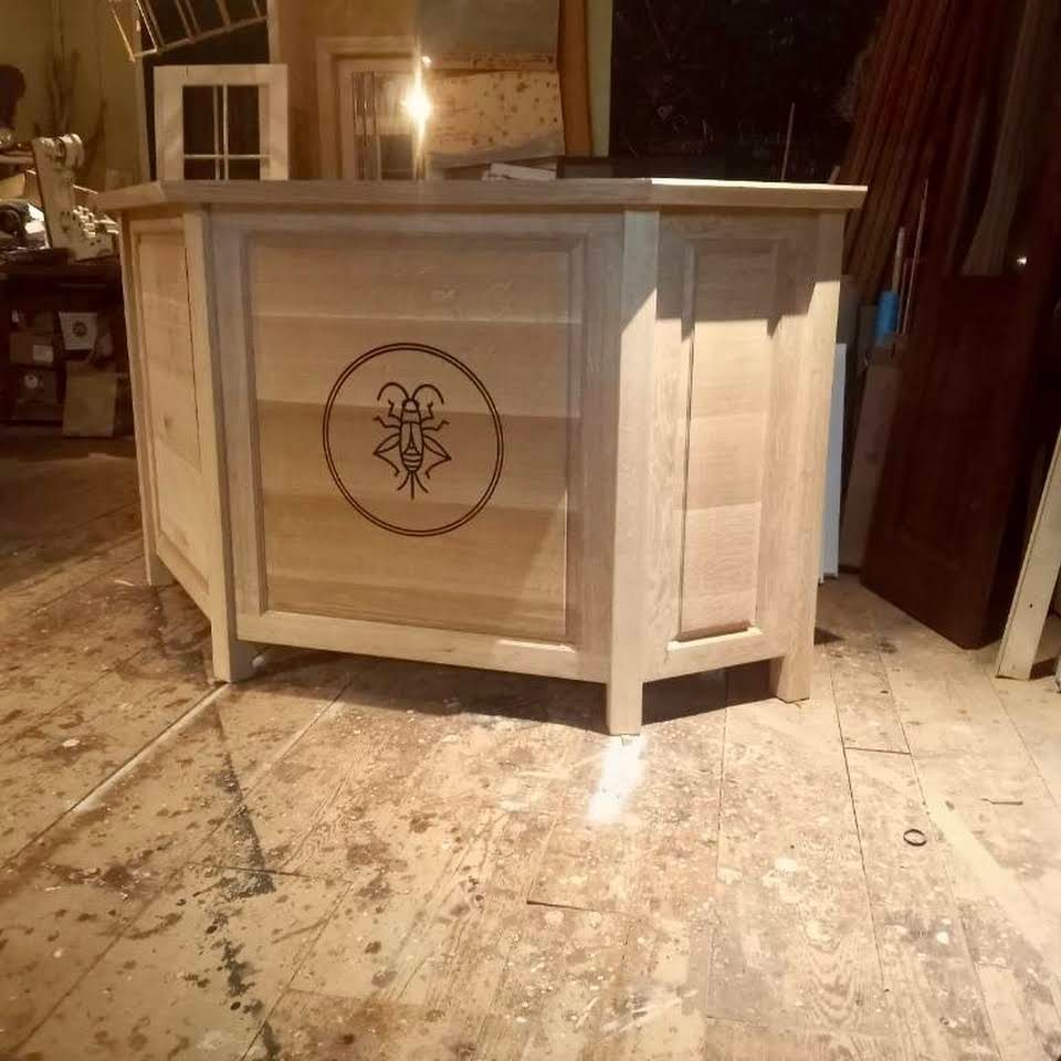 a custom wooden cabinet with a insect design on it