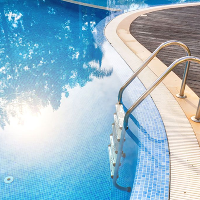 Steps into the pool with handrails in water reflex sun