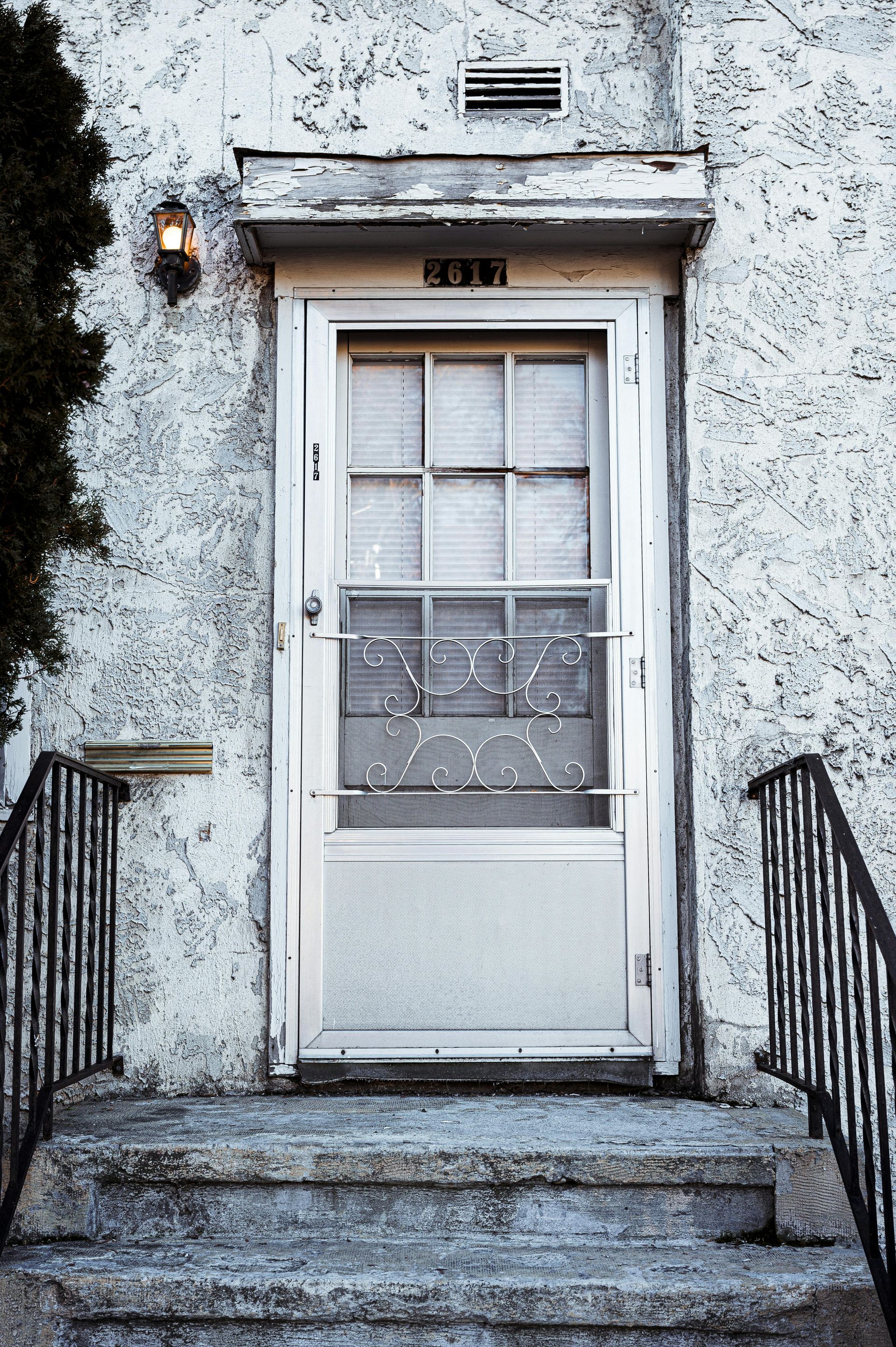 A white door on a building with the number 3831 on it