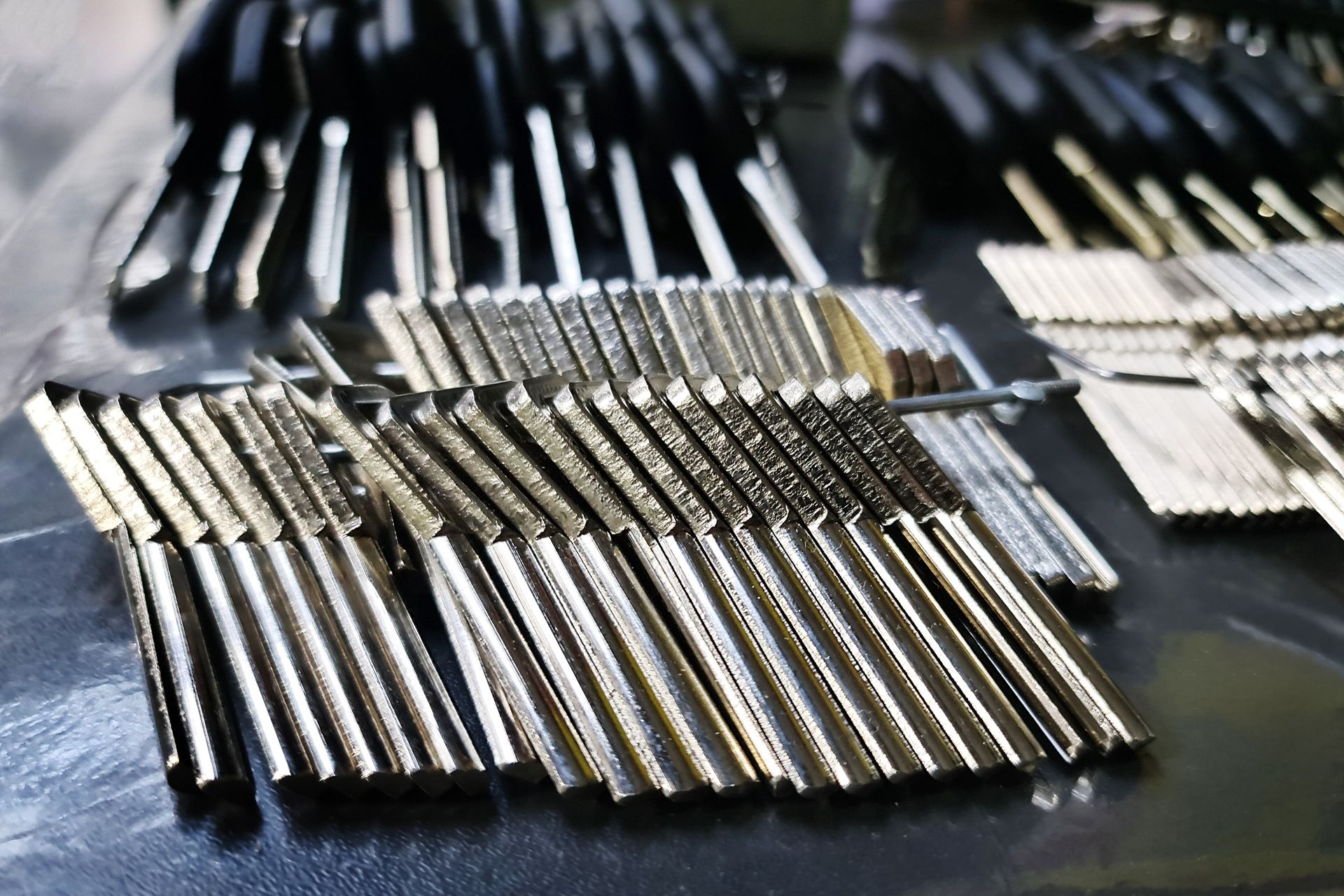 A bunch of metal sticks are lined up on a table