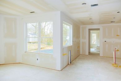 an empty room with a large window and a door