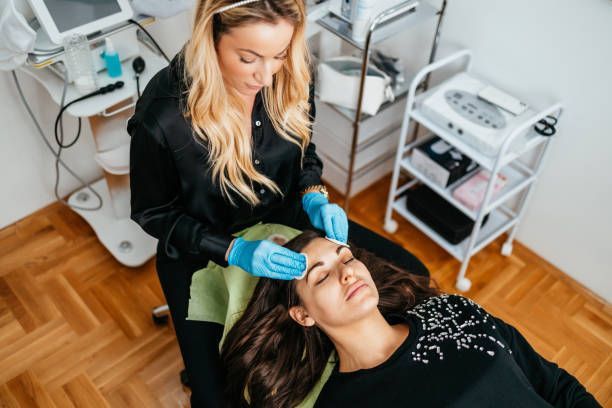 A woman receiving facial treatment. 