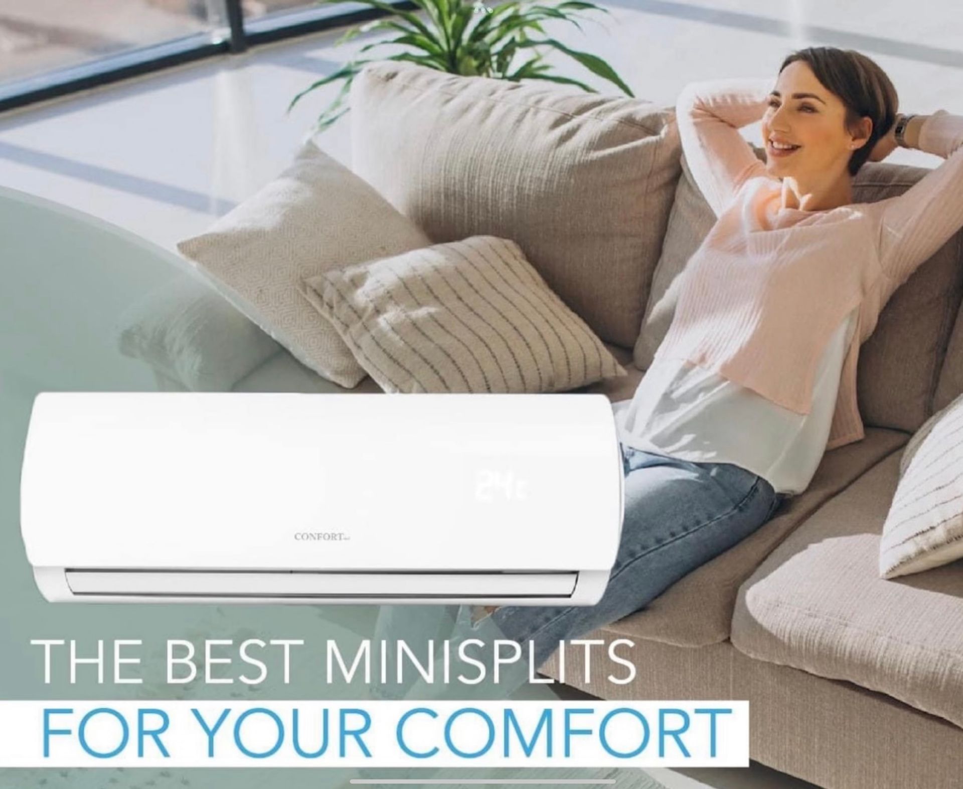 A woman is sitting on a couch next to a mini split