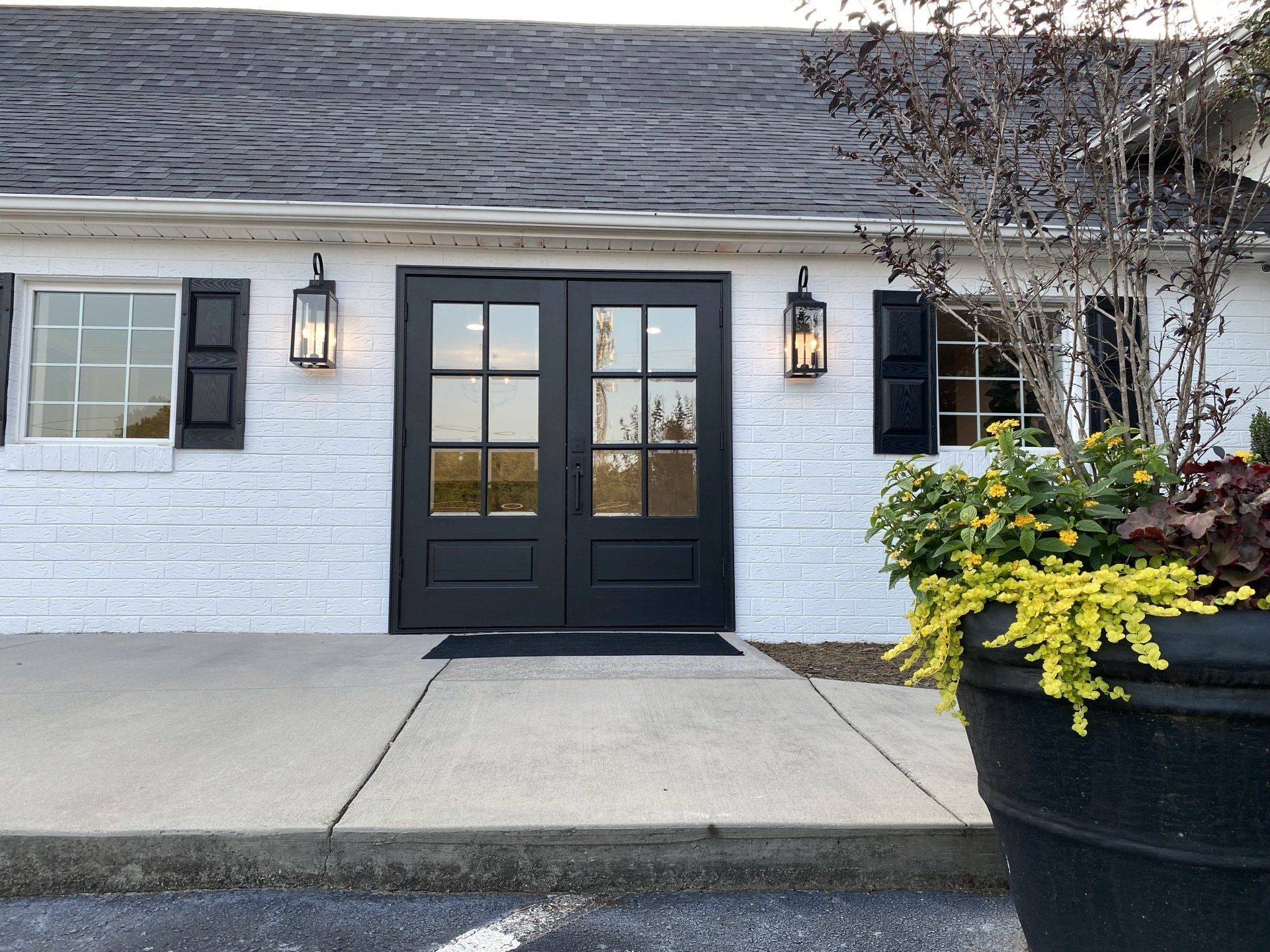 A white house with black doors and shutters